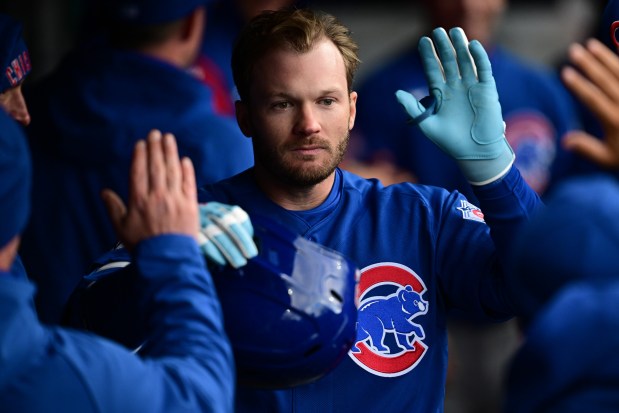Chicago Cubs' Ian Happ is congratulated in the dugout after hitting a solo home run off Cleveland Guardians relief pitcher Shawn Armstrong in the eighth inning in the second baseball game of a doubleheader, Sunday, April 5, 2026, in Cleveland. (AP Photo/David Dermer)