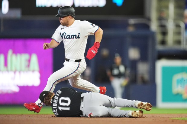 Miami Marlins' Jakob Marsee rounds second base past Chicago White Sox second baseman Chase Meidroth (10) on his way to third, on a single by Otto Lopez, during the first inning of a baseball game, Wednesday, April 1, 2026, in Miami. (AP Photo/Rebecca Blackwell)