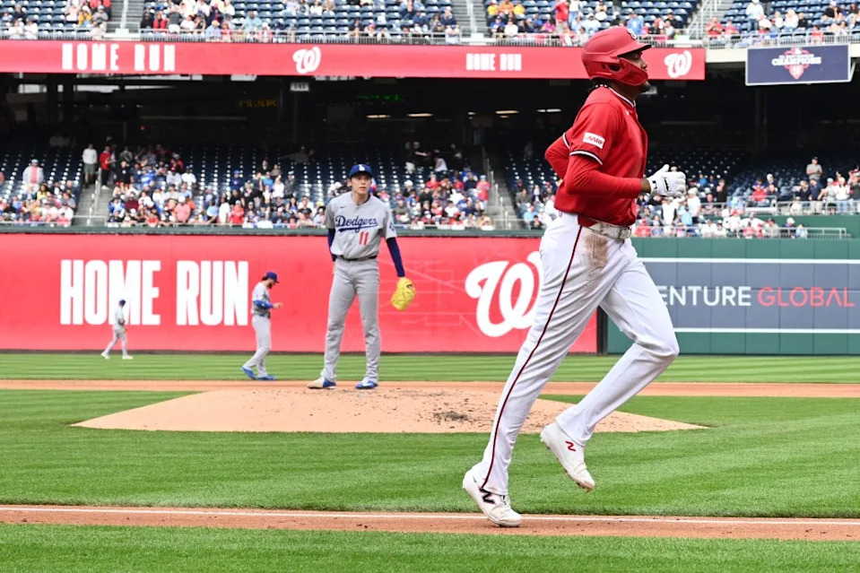 Sasaki watches James Wood round the bases after launching a home run. AP