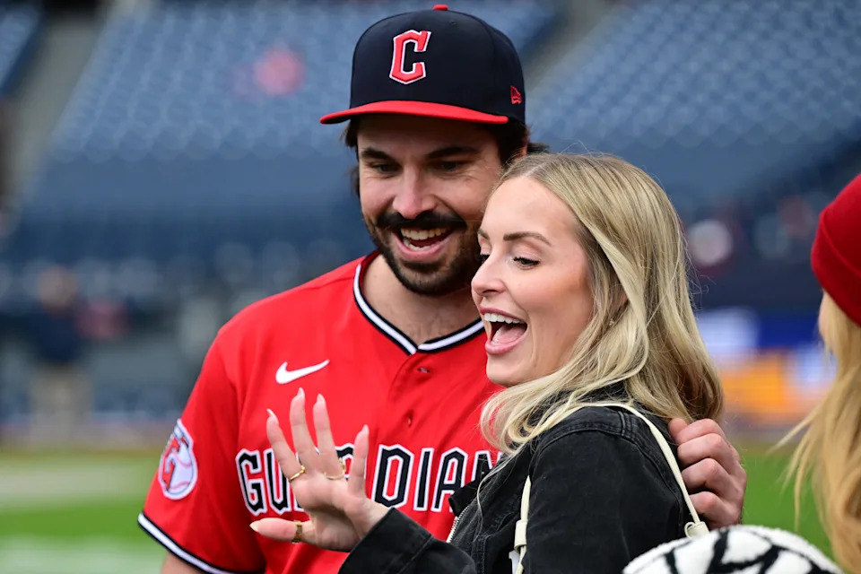 Apr 19, 2026; Cleveland, Ohio, USA; Cleveland Guardians catcher Austin Hedges (27) and fiancée Lexi Dickinson celebrate on the field after a marriage proposal by Hedges after a game against the Baltimore Orioles at Progressive Field. Mandatory Credit: David Dermer-Imagn Images