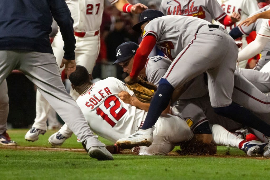 Jorge Soler (12) and Atlanta’s Reynaldo López (40) fight during the fifth inning of the Angels’ win over the Braves. AP
