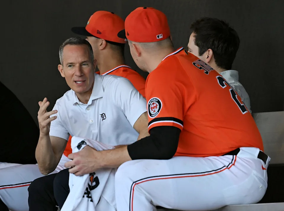 From left, Tigers owner Chris Ilitch, pitcher Tarik Skubal and president Scott Harris talk in the bullpen during the full squad workout at Tigers spring training in Lakeland, Fla. on Feb. 20, 2026.