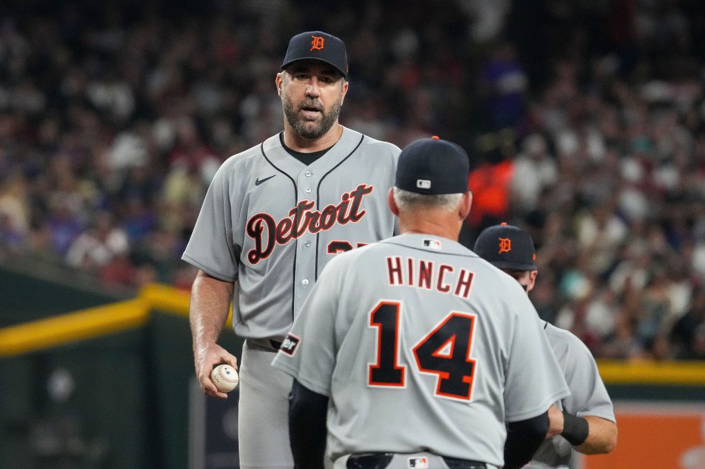 Detroit Tigers pitcher Justin Verlander holding a baseball, facing manager A.J. Hinch.