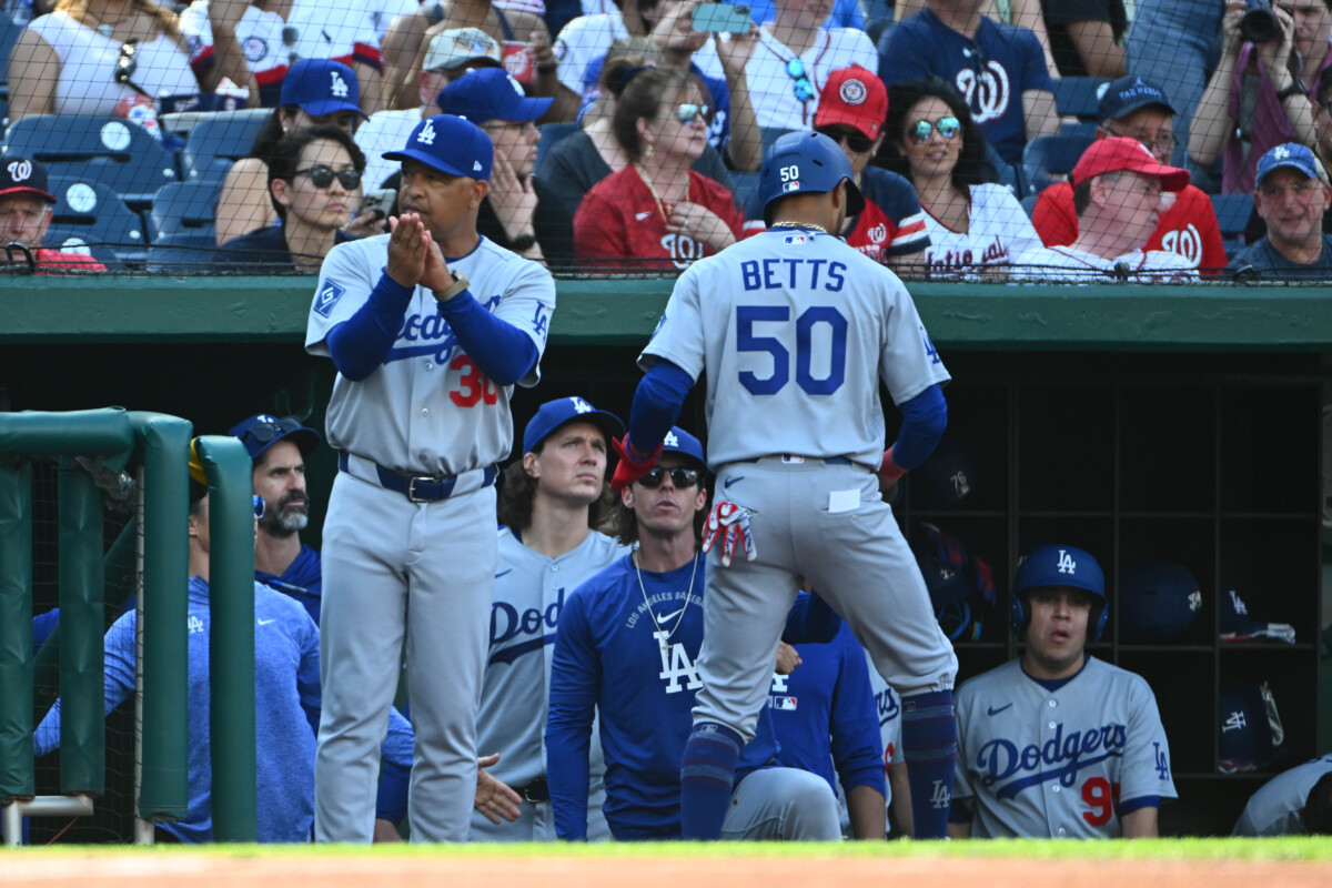 Apr 4, 2026; Washington, District of Columbia, USA; Los Angeles Dodgers shortstop Mookie Betts (50) is congratulated by teammates after scoring a run against the Washington Nationals during the first inning at Nationals Park. Mandatory Credit: Brad Mills-Imagn Images