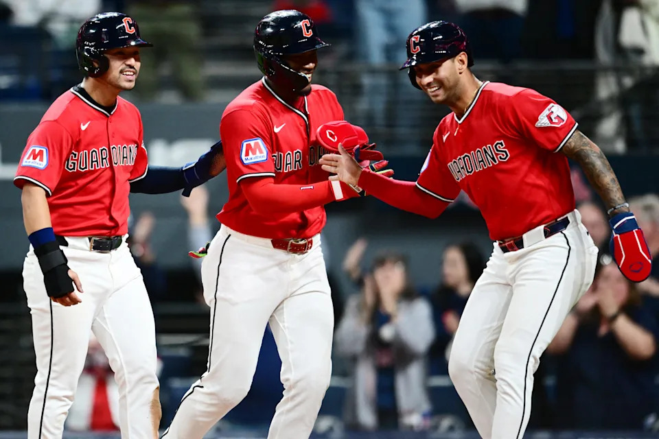 Steven Kwan, left, and Angel Martinez, middle, and Brayan Rocchio celebrate after scoring on a triple by Guardians DH Chase DeLauter (not pictured) during the eighth inning against the Houston Astros, April 21, 2026, in Cleveland.