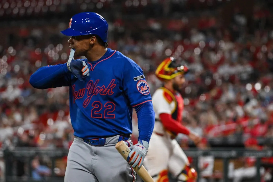 New York Mets left fielder Juan Soto (22) takes off his batting glove as he walks back to the dugout after striking out against the St. Louis Cardinals during the eighth inning at Busch Stadium. IMAGN IMAGES via Reuters Connect