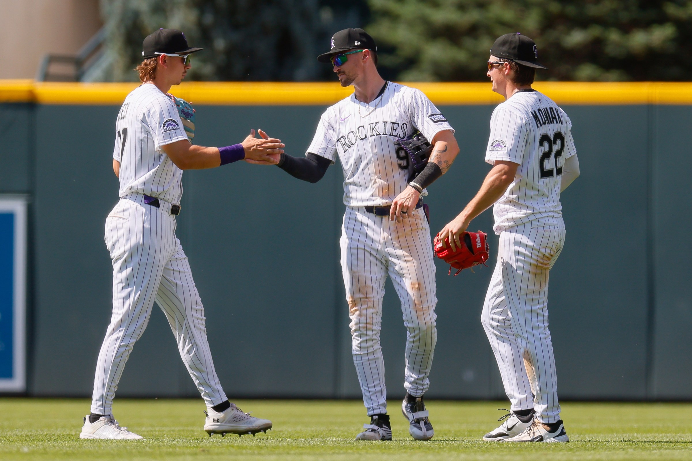 DENVER, CO - JULY 6: Jordan Beck #27, Brenton Doyle #9 and Mickey Moniak #22 of the Colorado Rockies celebrate after their 6-4 win against the Chicago White Sox at Coors Field on July 6, 2025 in Denver, Colorado. (Photo by Justin Edmonds/Getty Images)