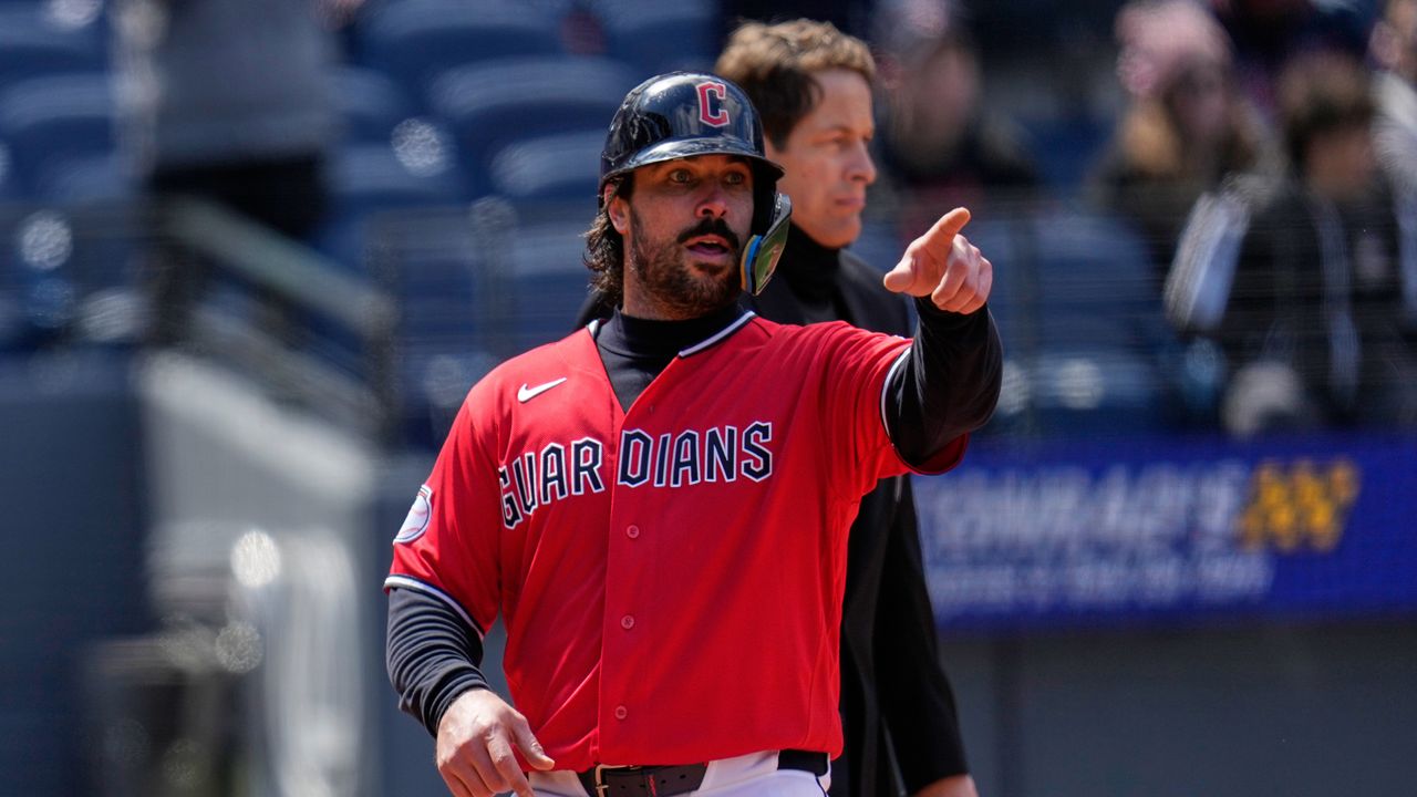 Cleveland Guardians' Austin Hedges gestures to first base as he scores on a single hit by Steven Kwan in the fifth inning of a baseball game against the Kansas City Royals in Cleveland, Tuesday, April 7, 2026. (AP Photo/Sue Ogrocki)