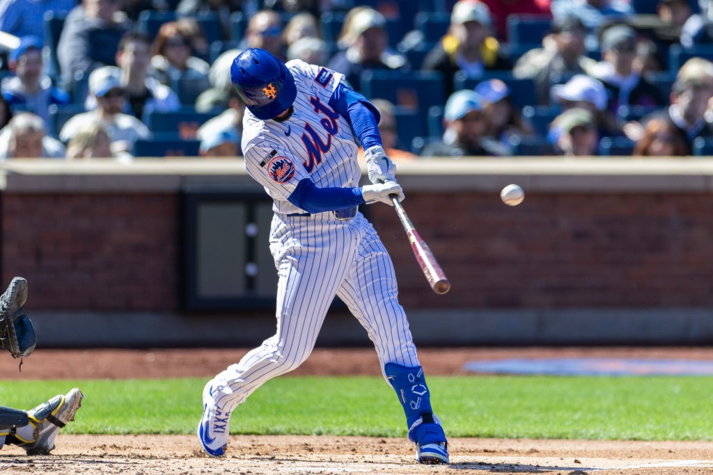 Marcus Semien (10) hits a SAC fly allowing New York Mets center fielder Luis Robert Jr. (88) to score in the second inning at Citi Field, Sunday, March 29, 2026, in Queens, NY.