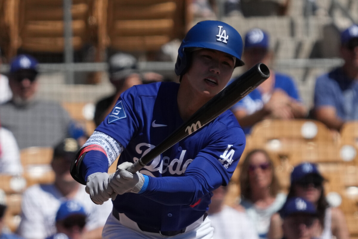 Mar 21, 2026; Phoenix, Arizona, USA; Los Angeles Dodgers second baseman Hyeseong Kim (6) hits against the Athletics in the first inning at Camelback Ranch-Glendale. Mandatory Credit: Rick Scuteri-Imagn Images