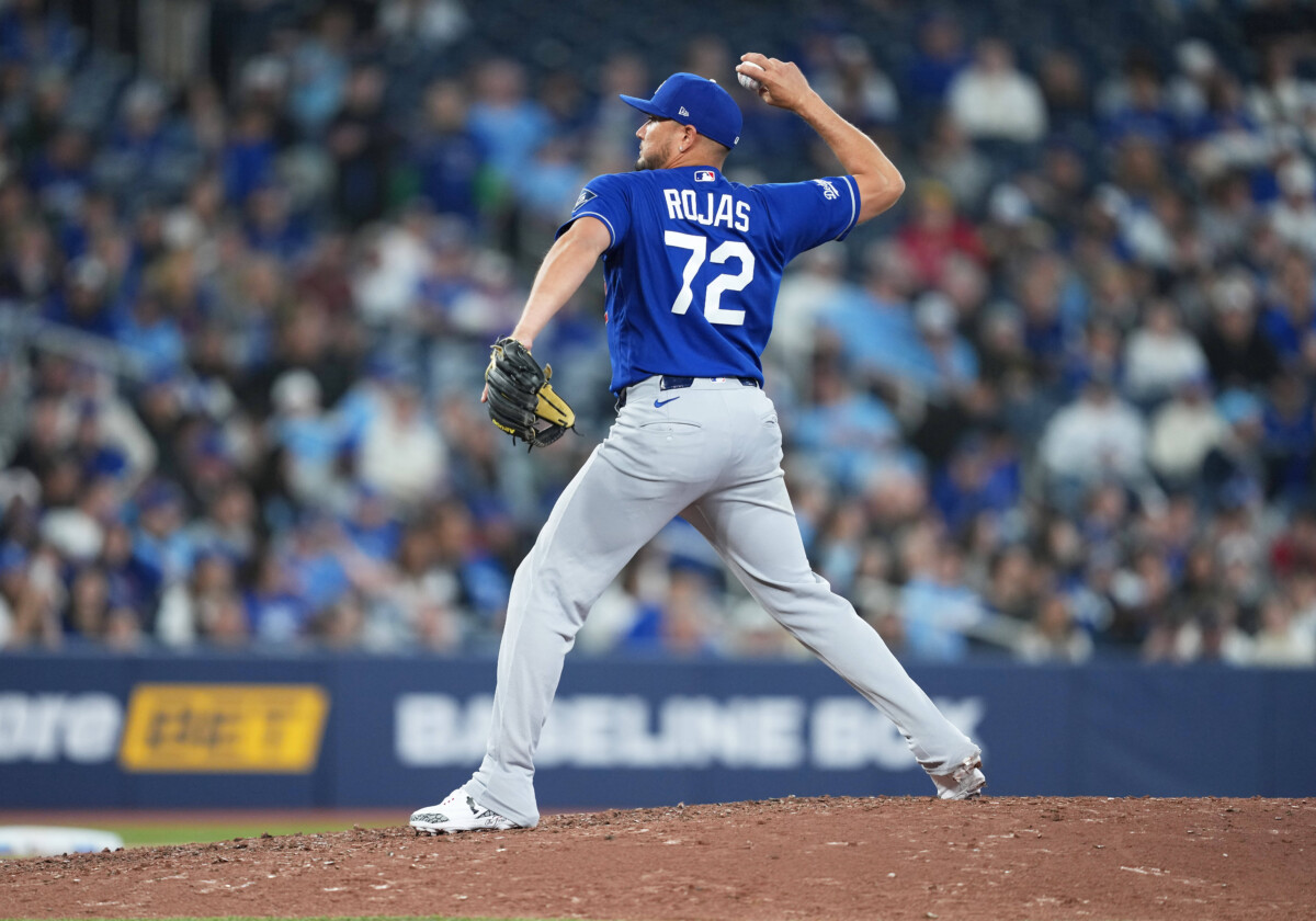 Apr 6, 2026; Toronto, Ontario, CAN; Los Angeles Dodgers infielder Miguel Rojas (72) throws a pitch against the Toronto Blue Jays at during the ninth inning at Rogers Centre. Mandatory Credit: Nick Turchiaro-Imagn Images