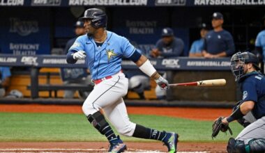 Seattle Mariners catcher Cal Raleigh, right, watches as Tampa Bay Rays' Yandy Diaz hits a lead off single off Seattle starter Bryce Miller during the first inning of a baseball game Sunday, Sept. 10, 2023, in St. Petersburg, Fla.
