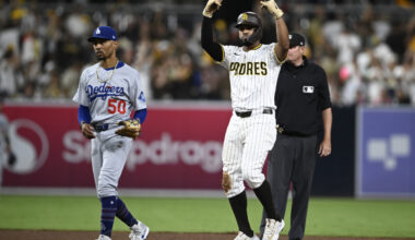 Aug 23, 2025; San Diego, California, USA; San Diego Padres shortstop Xander Bogaerts (2) celebrates after he hit an RBI double as Los Angeles Dodgers shortstop Mookie Betts (50) looks on during the eighth inning at Petco Park. Mandatory Credit: Denis Poroy-Imagn Images