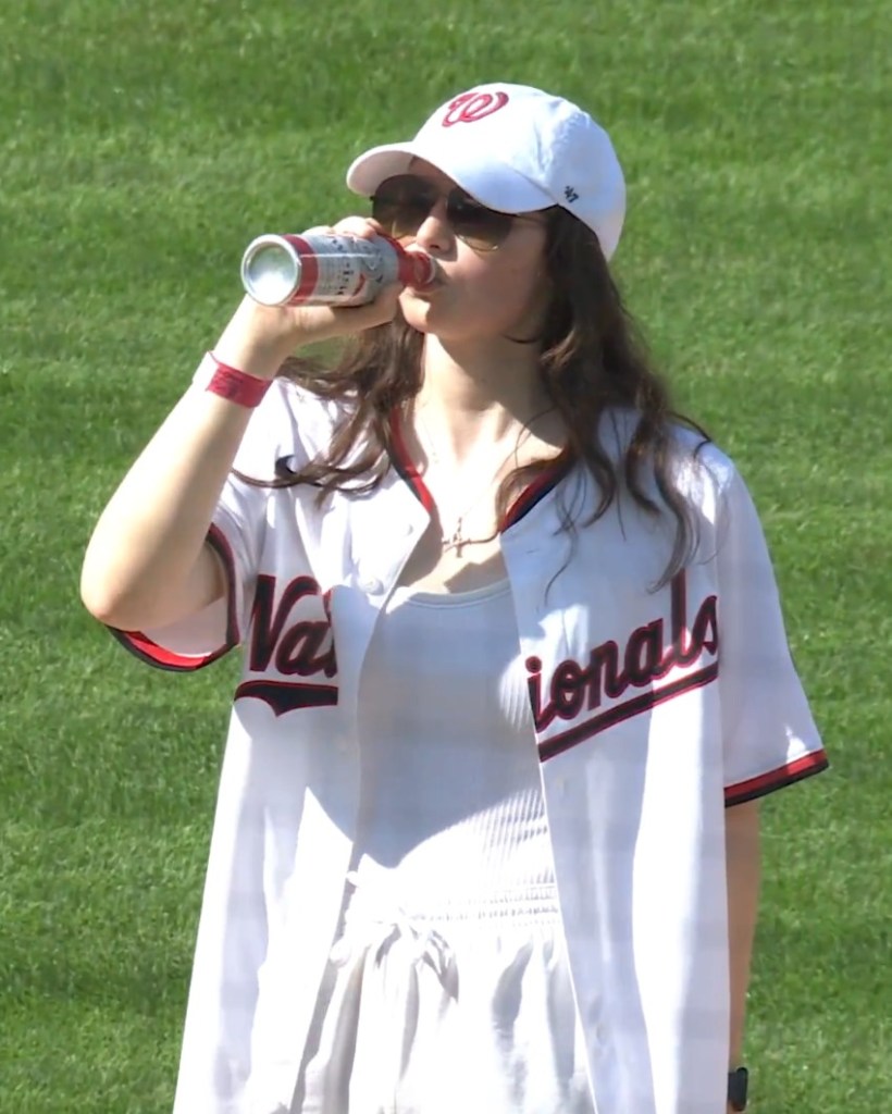 Nationals fan Sorcha Lewis celebrates her 21st birthday with a ceremonial "first sip" of beer on the mound on April 4, 2026.