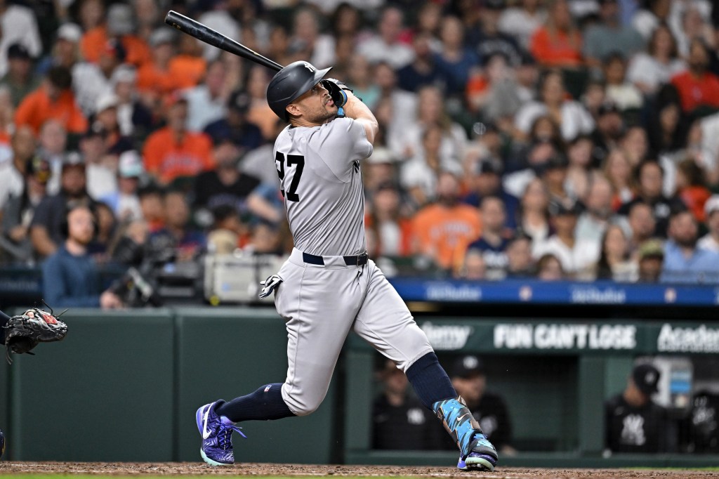 New York Yankees designated hitter Giancarlo Stanton (27) hits the ball.