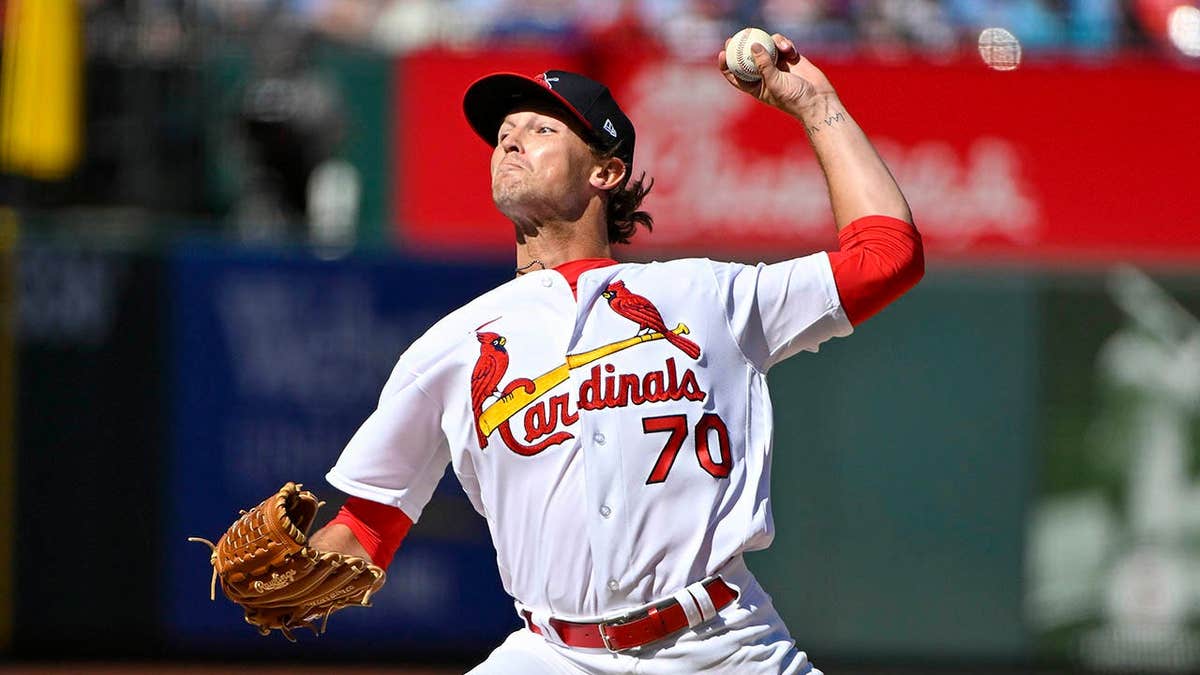 Packy Naughton pitching during a baseball game at Busch Stadium.