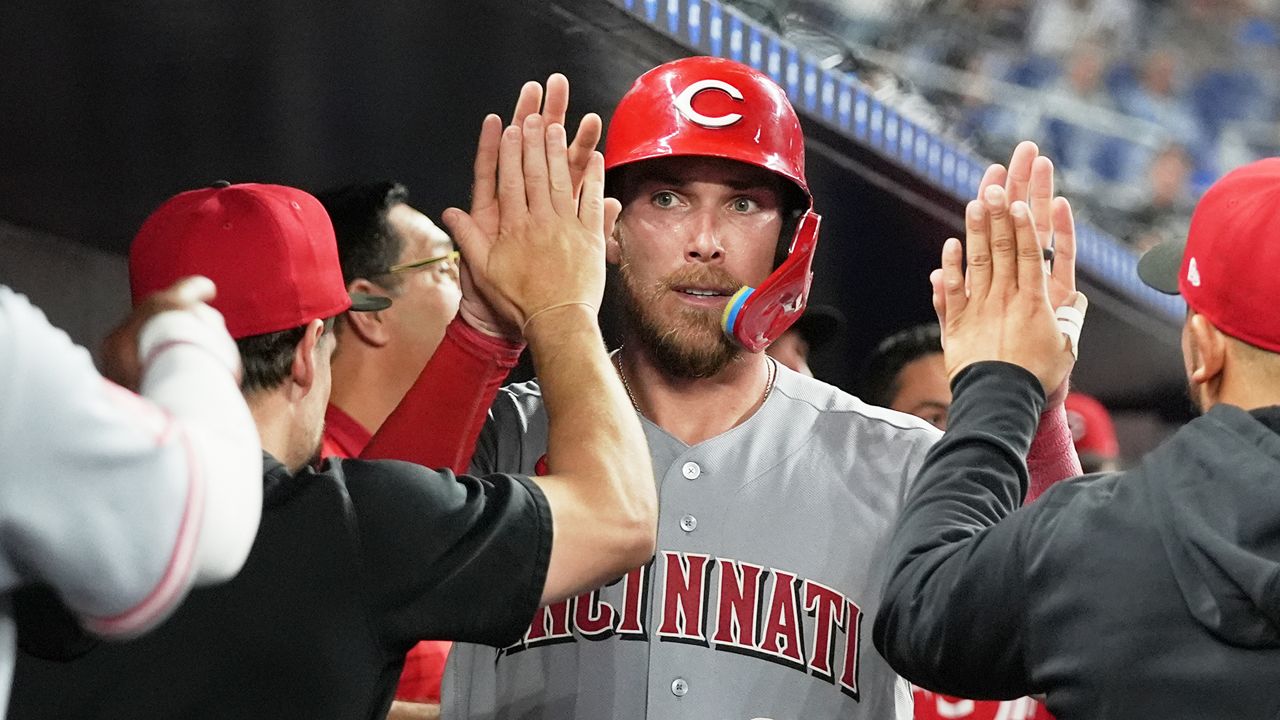 Cincinnati Reds' Tyler Stephenson (37) is congratulated in the dugout after scoring on a a double hit by Matt McLain during the 10th inning of a baseball game against the Miami Marlins, Tuesday, April 7, 2026, in Miami. (AP Photo/Lynne Sladky)