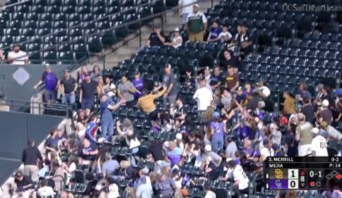 Rockies fan laying out to catch a foul ball