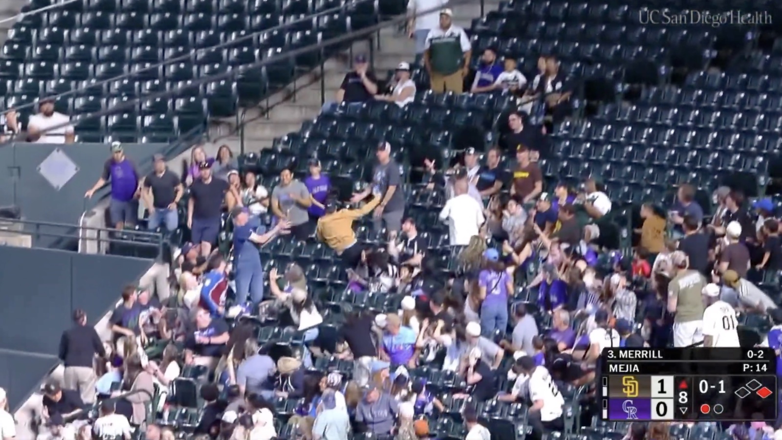 Rockies fan laying out to catch a foul ball