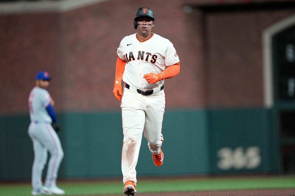 Rafael Devers of the San Francisco Giants rounding the bases after hitting a solo home run.