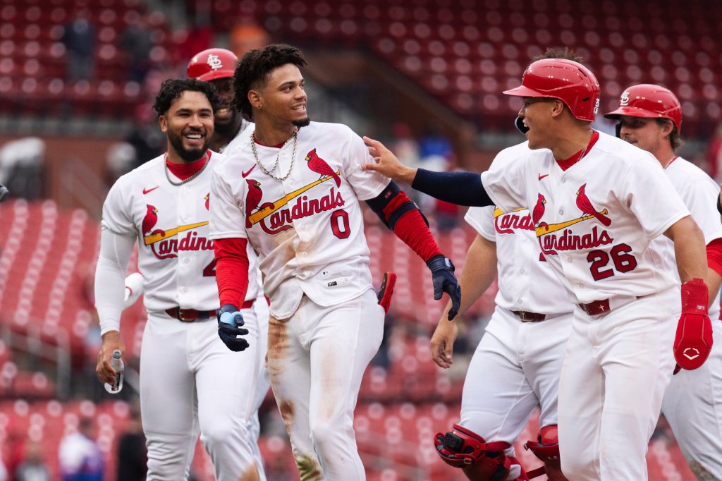 Masyn Winn celebrating with teammates after hitting a game-winning single.