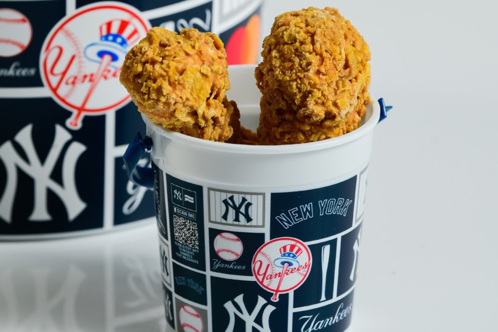 Two pieces of fried chicken in a New York Yankees branded cup.