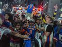 New York Knicks fans celebrate after the team defeated the Cleveland Cavaliers to reach the NBA Finals.