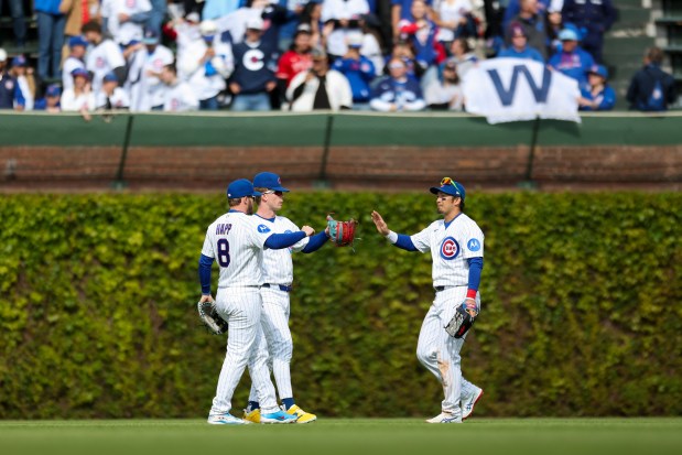 Chicago Cubs left fielder Ian Happ, center fielder Pete Crow-Armstrong and right fielder Seiya Suzuki celebrate after they defeated the Arizona Diamondbacks 8-4 at Wrigley Field on May 3, 2026. (Eileen T. Meslar/Chicago Tribune)