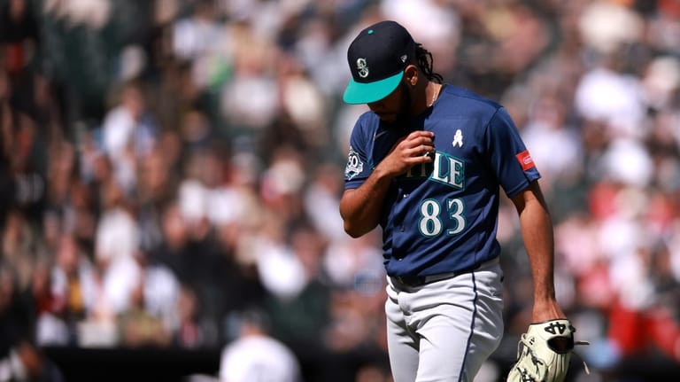 Seattle Mariners' pitcher Eduard Bazardo returns to the dugout after...