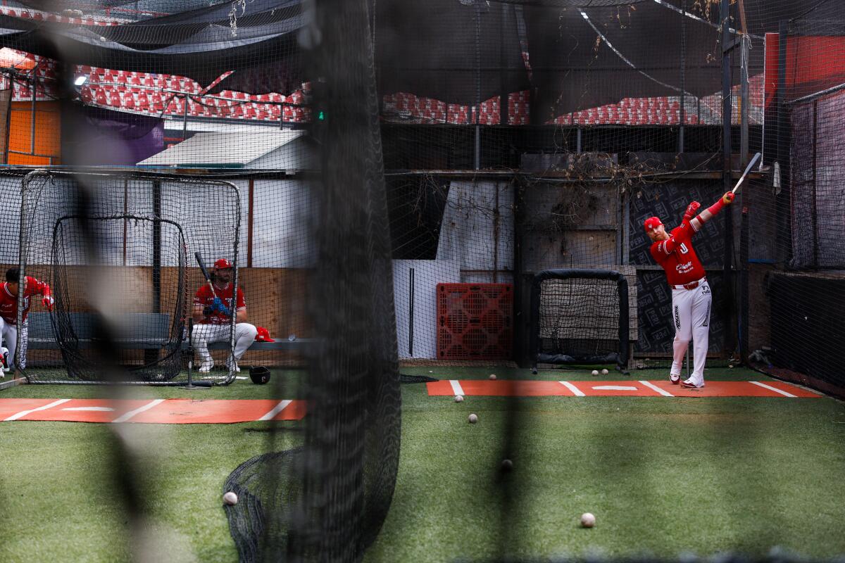 Justin Turner follows through on a swing while warming up in the batting cages before the start of Saturday's Tijuana Toros game.