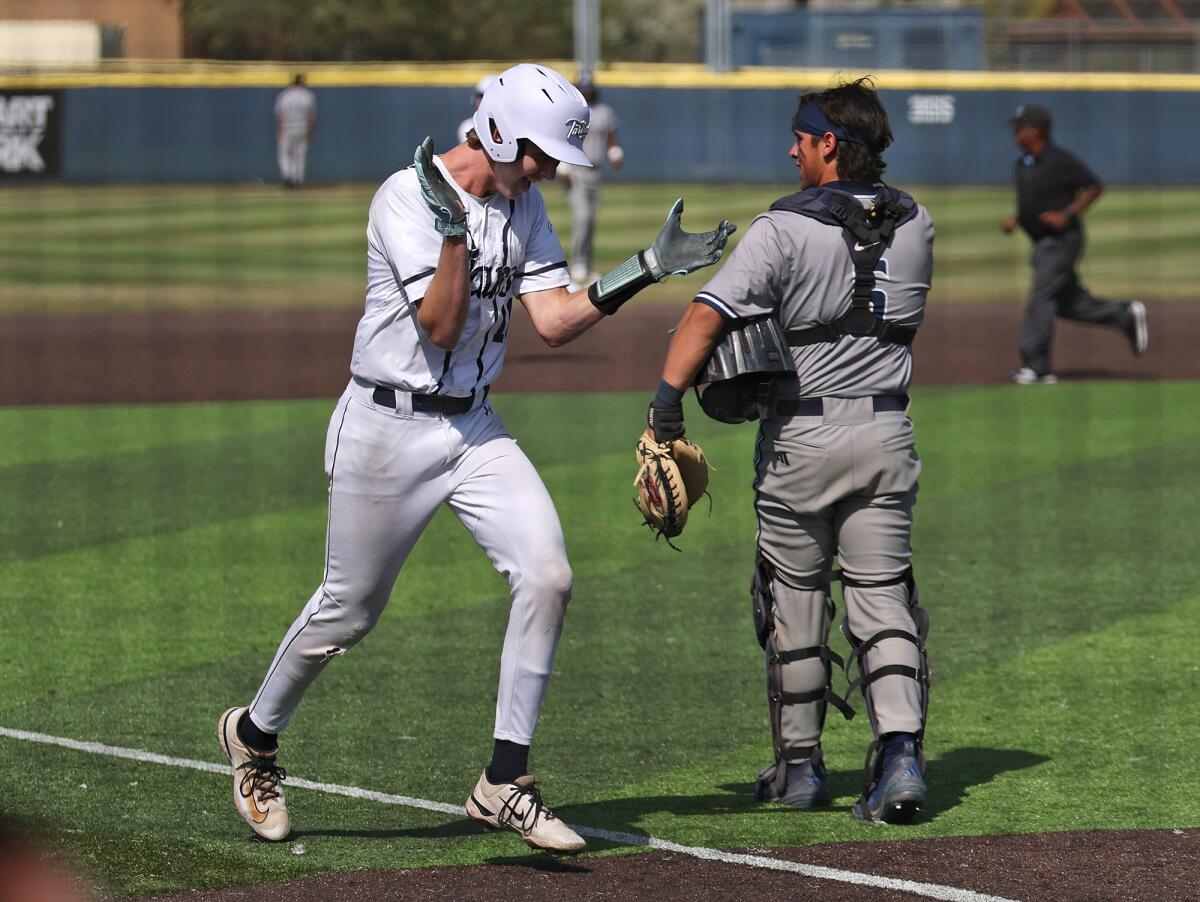 Newport Harbor's Henry Mann (18) trots to home for a run after a homer by teammate Grant Horsely.