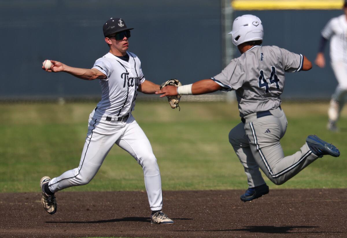 Newport Harbor infielder Grant Horsley (30) completes a double play to get out of the inning on Friday.