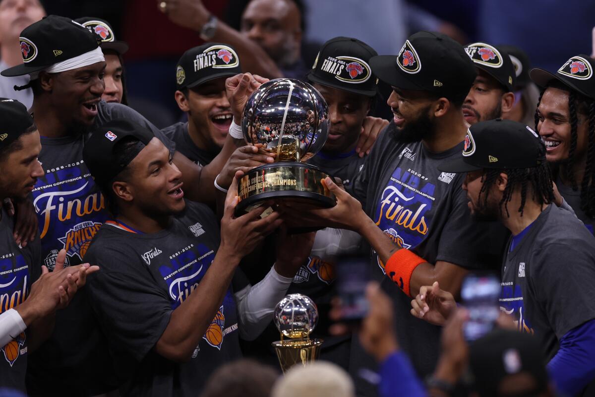 Knicks center Karl-Anthony Towns and teammates celebrate after winning the Eastern Conference finals Monday in Cleveland