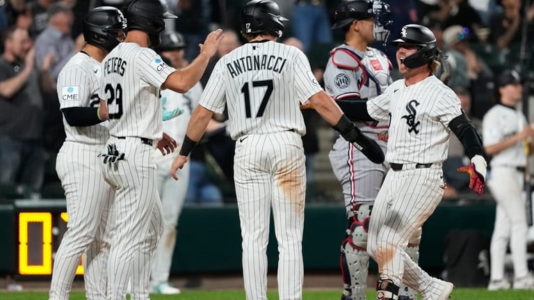 Chicago White Sox's Chase Meidroth, right, celebrates with Edgar Quero,...