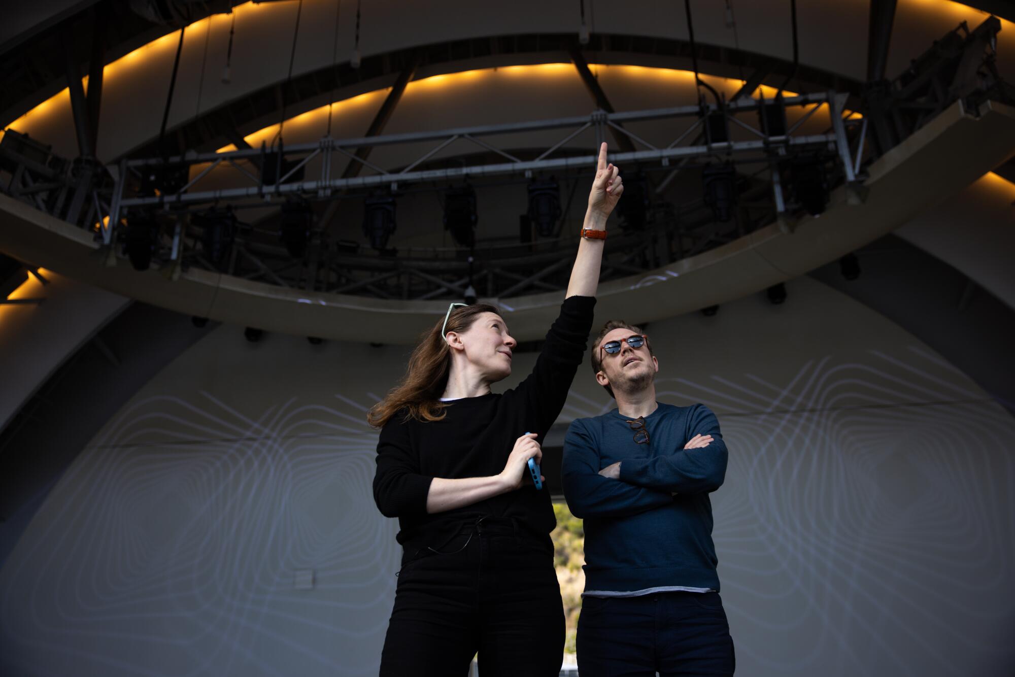 Meghan Umber points out the ceiling and lights to Daniel Harding at the Hollywood Bowl.