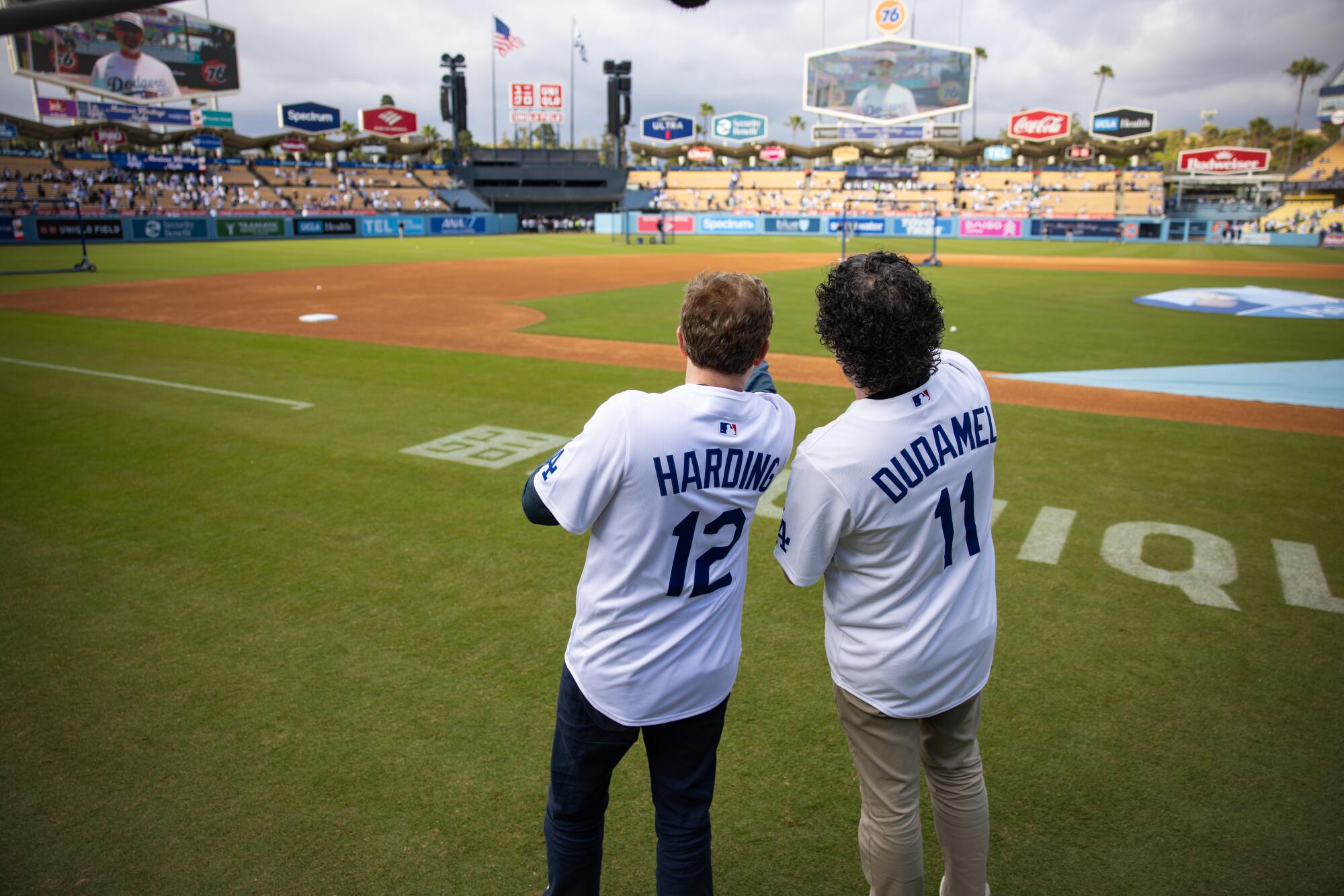 Daniel Harding, left, and Gustavo Dudamel on the field before a Dodgers vs. Rockies baseball game at Dodger Stadium.