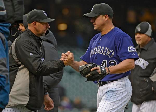 Walt Weiss, manager of the Colorado Rockies shakes hands with Rafael Betancourt after their win over the New York Mets April 16, 2013 at Coors Field. The Colorado Rockies defeated the New York Mets 8-4 in the first of a double header. (File Photo By John Leyba/The Denver Post)