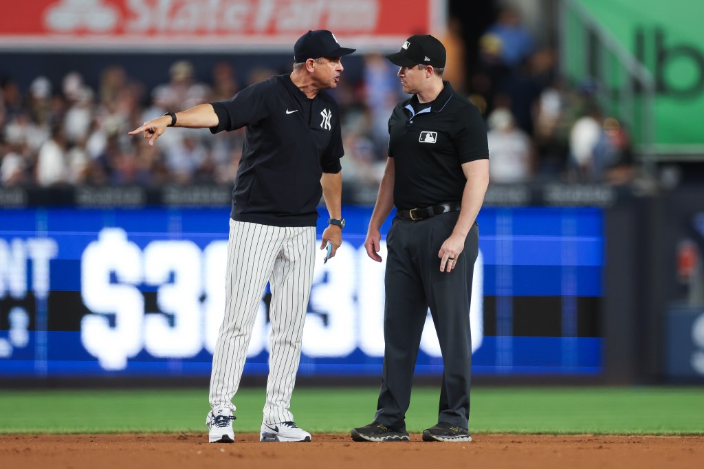 Manager Aaron Boone #17 of the New York Yankees yells at second base umpire Brennan Miller #55 during the eighth inning against the Toronto Blue Jays at Yankee Stadium on May 19, 2026 in the Bronx borough of New York City. Boone was ejected from the game. 