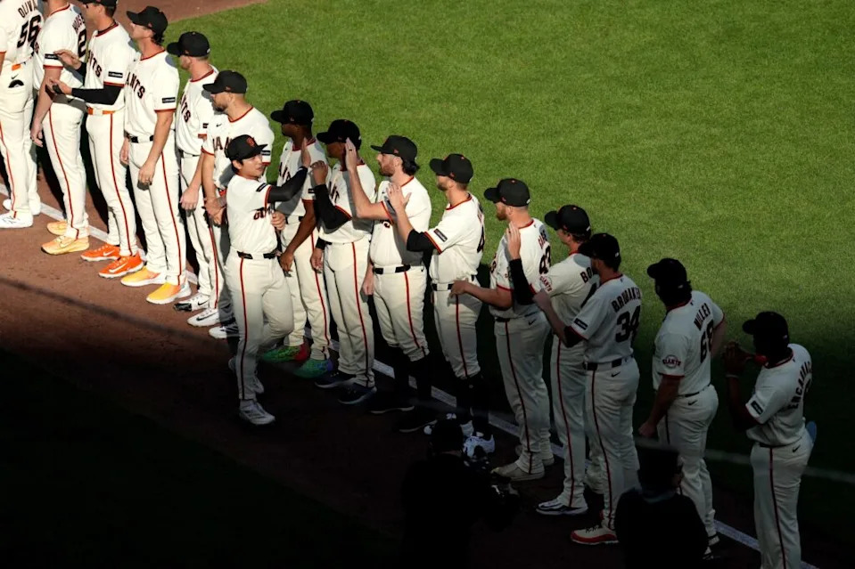 San Francisco Giants outfielder Jung Hoo Lee (51) high fives teammates before the start of the game against the New York Yankees at Oracle Park.