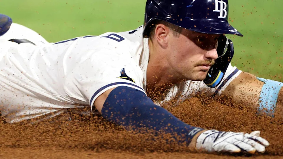 Apr 1, 2025; St. Petersburg, Florida, USA; Tampa Bay Rays center fielder Jonny DeLuca (21) slides into third base after hitting a triple against the <a class="link " href="https://sports.yahoo.com/mlb/teams/pittsburgh/" data-i13n="sec:content-canvas;subsec:anchor_text;elm:context_link" data-ylk="slk:Pittsburgh Pirates;sec:content-canvas;subsec:anchor_text;elm:context_link;itc:0" data-yga="{"yLinkElement":"context_link","yModuleName":"content-canvas","yLinkText":"Pittsburgh Pirates","ySubModuleName":"anchor_text","yHasCommerce":false}">Pittsburgh Pirates</a> in the eighth inning at George M. Steinbrenner Field. Mandatory Credit: Nathan Ray Seebeck-Imagn Images
