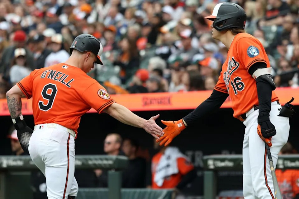 Baltimore Orioles right fielder Tyler O'Neill (9) celebrates with Baltimore Orioles first baseman Coby Mayo (16) after scoring a run during the seventh inning against the Boston Red Sox at Oriole Park at Camden Yards.