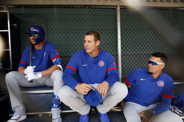 Cubs' Kris Bryant Anthony Rizzo and Javier Báez sit in a dugout during spring training at sloan park on Feb. 21, 2020, in Mesa, Ariz. (Armando L. Sanchez/Chicago Tribune)