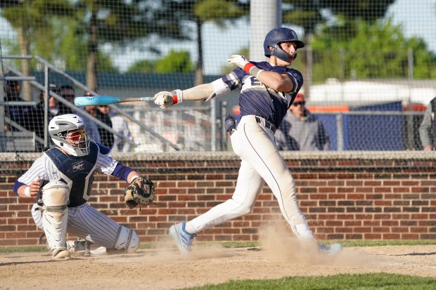 Oswego East's Dominic Battista (14) drives in a run off a single against Oswego during a Southwest Prairie Conference game in Oswego on Monday, May 11, 2026. (Sean King / For The Beacon-News)