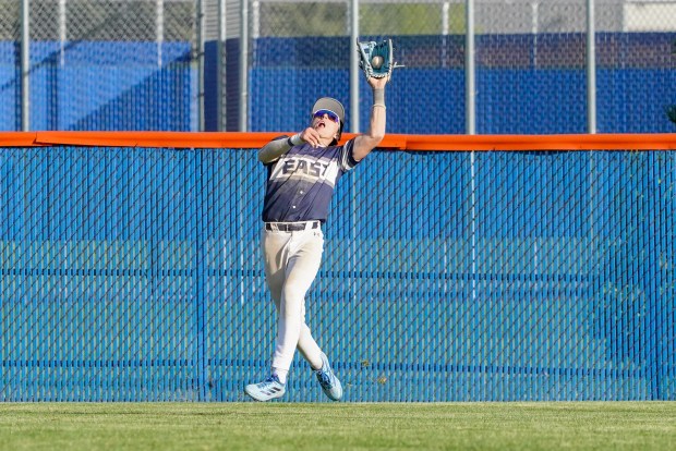 Oswego East's Dominic Battista (14) makes a catch on a deep fly ball for an out against Oswego during a Southwest Prairie Conference game in Oswego on Monday, May 11, 2026. (Sean King / For The Beacon-News)