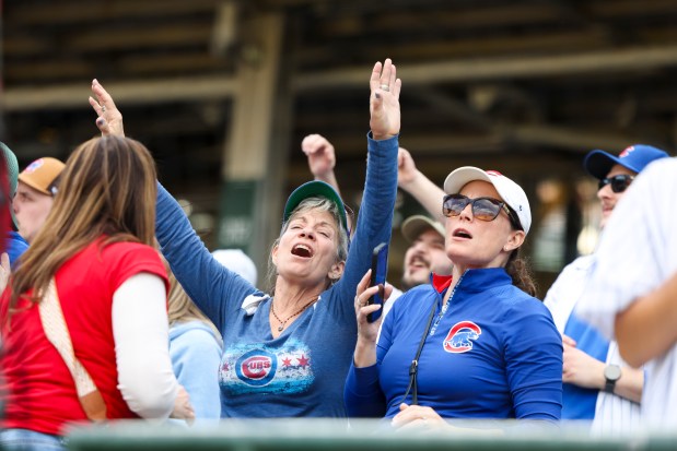 Fans sing and dance to "Go, Cubs, Go" after the Chicago Cubs defeated the Arizona Diamondbacks 8-4 at Wrigley Field on May 3, 2026. (Eileen T. Meslar/Chicago Tribune)