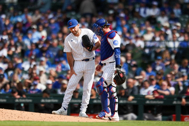 Chicago Cubs catcher Carson Kelly (15) speaks to pitcher Corbin Martin (38) after Martin had two high pitches in the ninth inning against the Arizona Diamondbacks at Wrigley Field on May 3, 2026. (Eileen T. Meslar/Chicago Tribune)