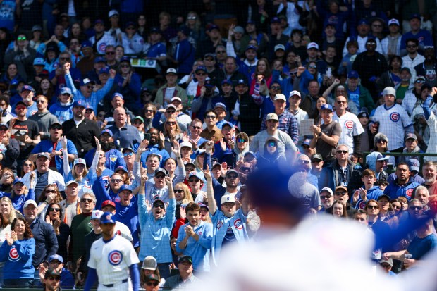 Fans cheer as Chicago Cubs first baseman Michael Busch slides safely into third base for a 3-RBI triple in the fifth inning against the Arizona Diamondbacks at Wrigley Field on May 3, 2026. (Eileen T. Meslar/Chicago Tribune)
