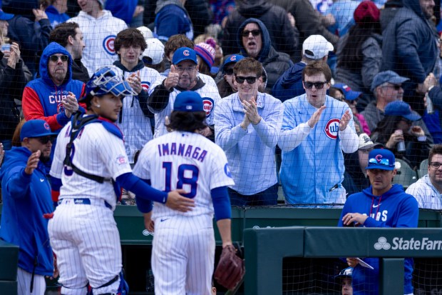 Chicago Cubs catcher Miguel Amaya pats the back of starting pitcher Shota Imanaga as he leaves the field in the eighth inning of a game against the Arizona Diamondbacks at Wrigley Field in Chicago on May 2, 2026. (Josh Boland/Chicago Tribune)