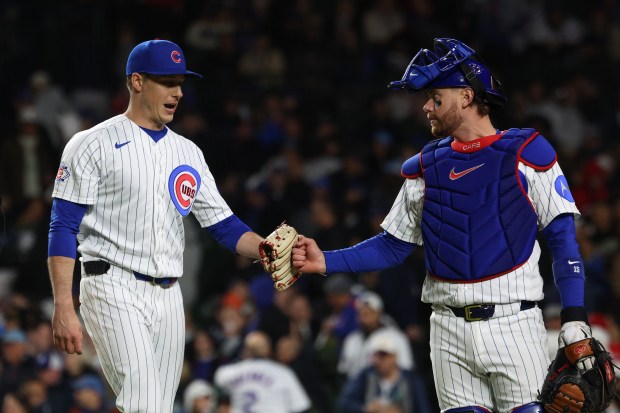 Cubs catcher Carson Kelly, right, gives a fist bump to pitcher Phil Maton after the top of the eighth inning against the Reds at Wrigley Field on May 6, 2026, in Chicago. (John J. Kim/Chicago Tribune)