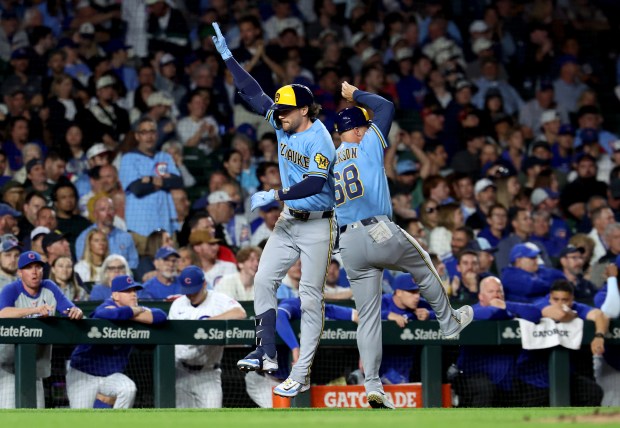 Milwaukee Brewers second baseman Brice Turang (left) is congratulated by third base coach Matt Erickson (68) after Turang hit a two-run home run in the eighth inning of a game against the Chicago Cubs at Wrigley Field in Chicago on May 19, 2026. (Chris Sweda/Chicago Tribune)